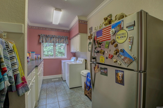 laundry area featuring ornamental molding, light tile patterned flooring, and washer and dryer