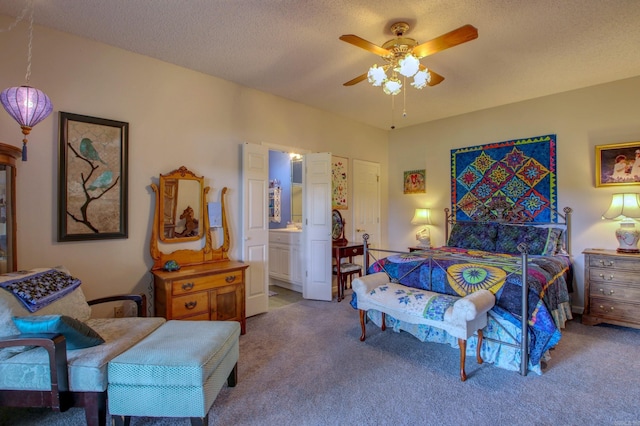 bedroom with a textured ceiling, carpet floors, ceiling fan, and connected bathroom