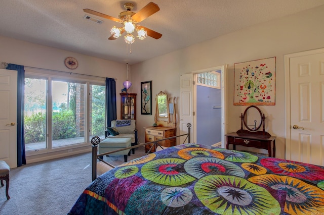 carpeted bedroom with a textured ceiling and ceiling fan