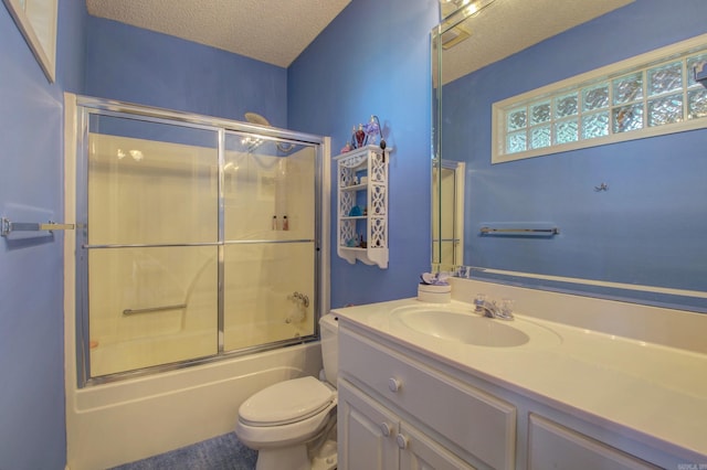 full bathroom with vanity, a textured ceiling, toilet, and combined bath / shower with glass door