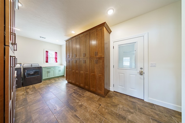 entryway featuring a textured ceiling and washer / dryer