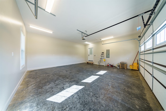 garage featuring electric panel and a garage door opener