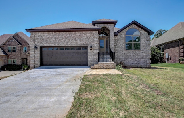 view of front of house featuring a garage and a front lawn