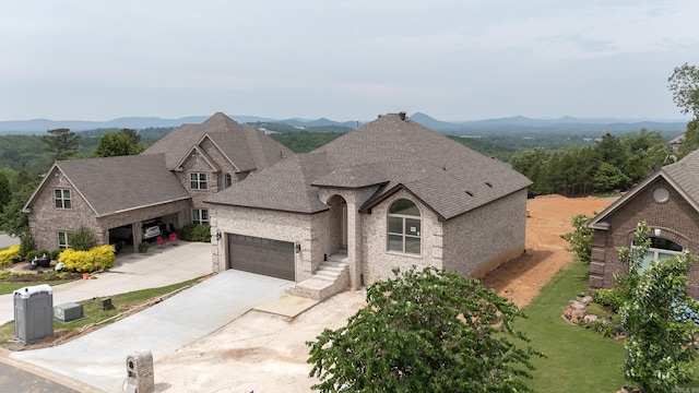 french country inspired facade featuring a mountain view and a garage