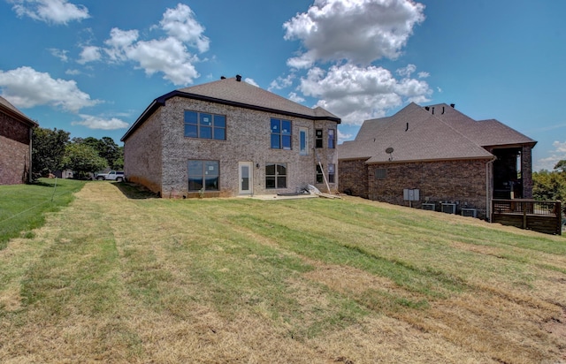 rear view of property with a lawn