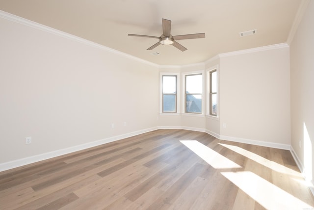 spare room featuring ceiling fan, light hardwood / wood-style floors, and crown molding