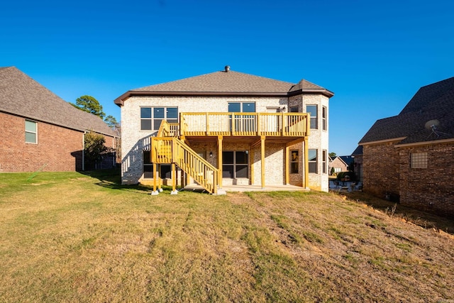 rear view of house with a lawn and a deck