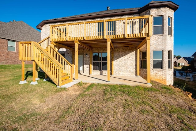 rear view of house featuring a lawn, a patio area, and a wooden deck