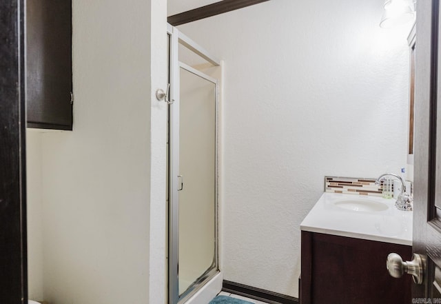 bathroom featuring vanity and a shower with shower door