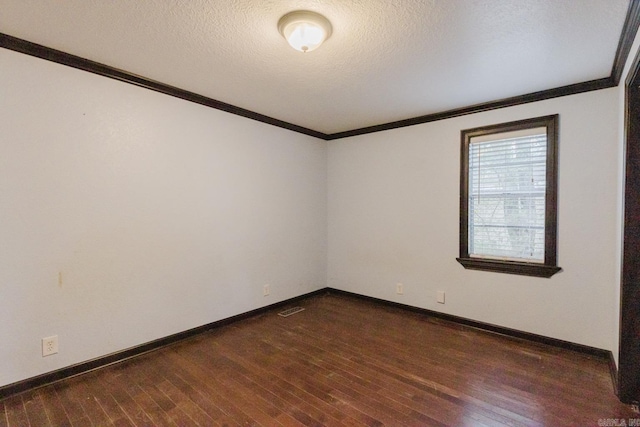 empty room with dark hardwood / wood-style flooring, a textured ceiling, and crown molding