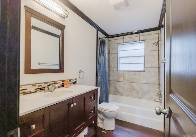 full bathroom with ornamental molding, wood-type flooring, vanity, shower / bath combo, and toilet