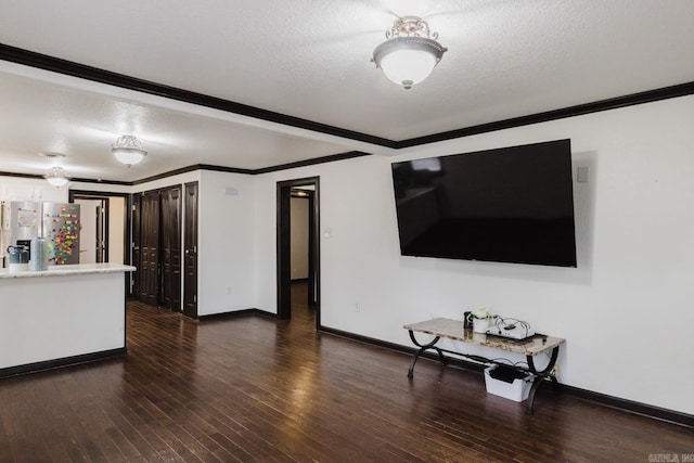 living room featuring dark hardwood / wood-style floors, a textured ceiling, and ornamental molding