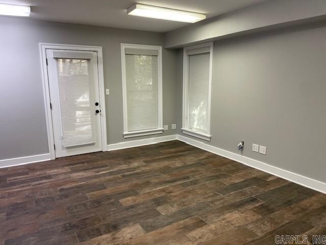 unfurnished room with dark hardwood / wood-style floors