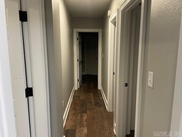 hallway featuring dark hardwood / wood-style flooring