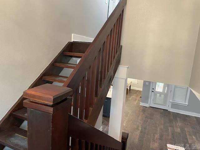 stairs featuring wood-type flooring