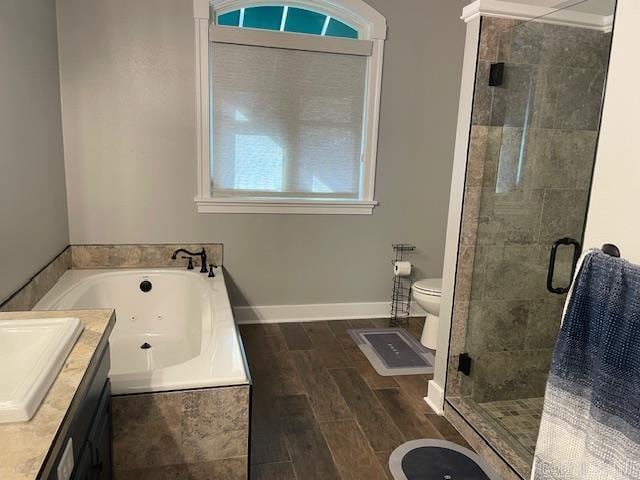 full bathroom with toilet, wood-type flooring, separate shower and tub, and vanity