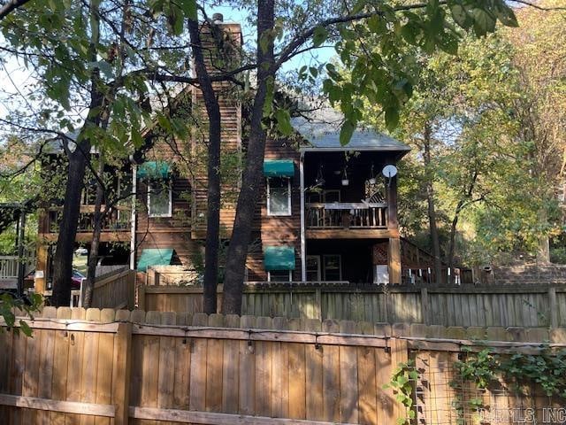 back of house featuring a balcony