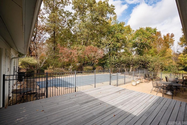 wooden terrace with a patio and a covered pool