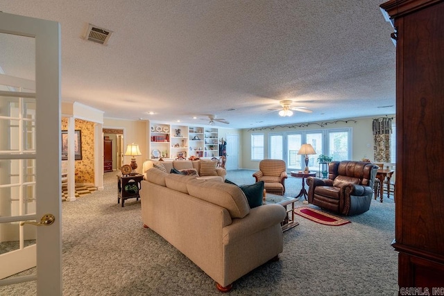 living room featuring carpet flooring, a textured ceiling, and ceiling fan