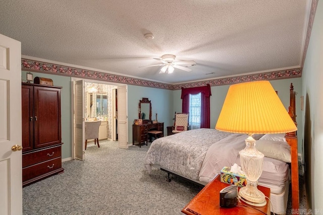 bedroom with ensuite bath, ceiling fan, a textured ceiling, and ornamental molding