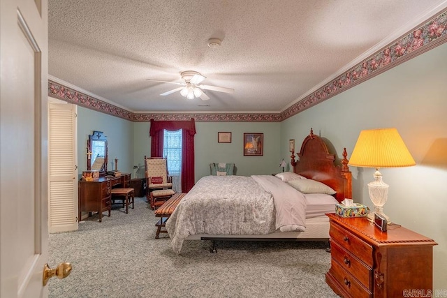 carpeted bedroom featuring ceiling fan, a closet, a textured ceiling, and ornamental molding