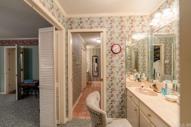 bathroom featuring vanity, a textured ceiling, ornamental molding, and tile patterned flooring