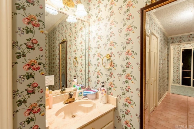 bathroom featuring vanity, a textured ceiling, and ornamental molding