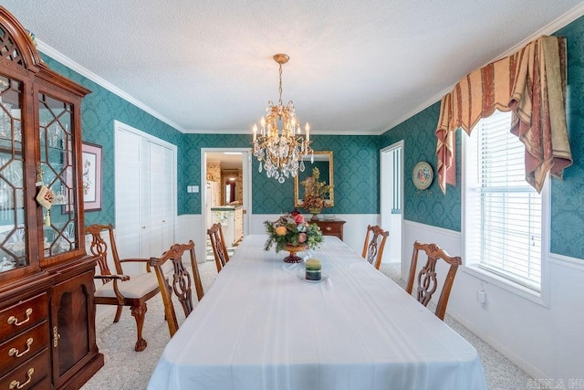 carpeted dining area with crown molding, a healthy amount of sunlight, a textured ceiling, and an inviting chandelier