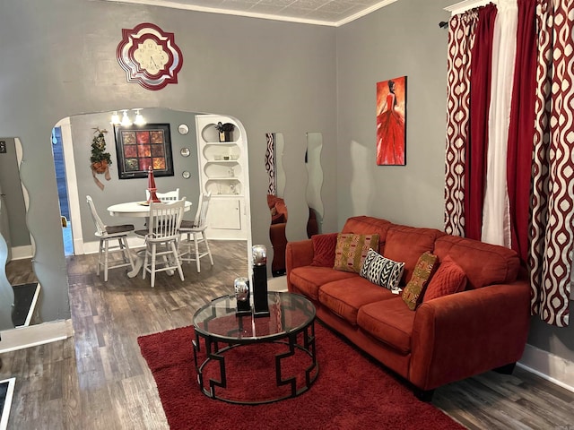 living room featuring ornamental molding and dark hardwood / wood-style flooring