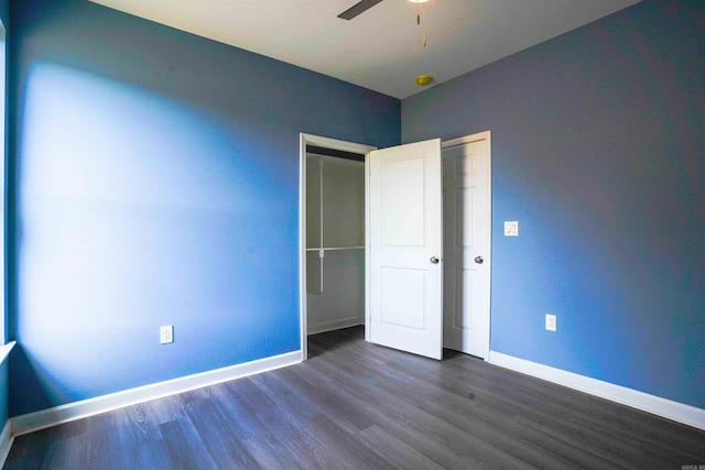 unfurnished bedroom featuring ceiling fan, a closet, and dark hardwood / wood-style flooring