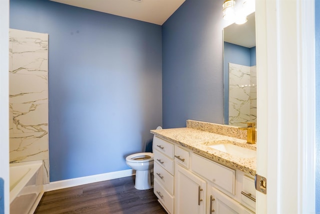 bathroom featuring vanity, hardwood / wood-style flooring, and toilet