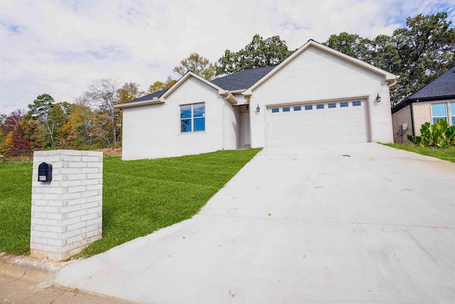 ranch-style home featuring a front lawn and a garage