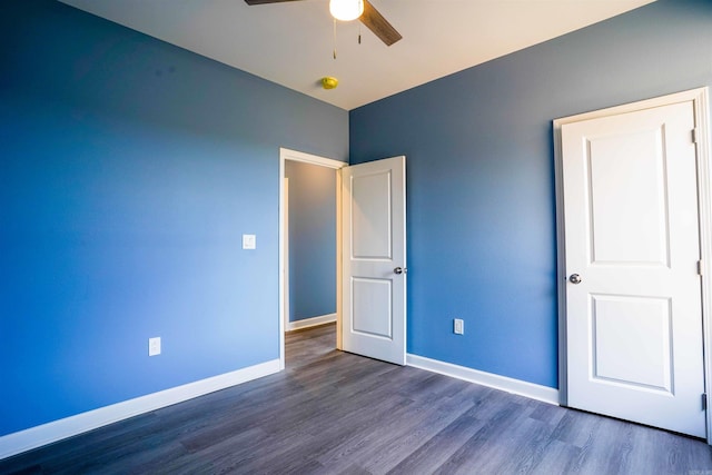 unfurnished bedroom with dark wood-type flooring and ceiling fan