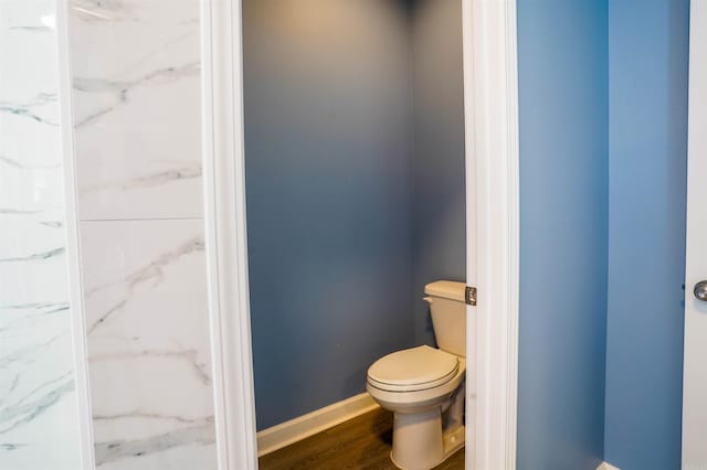 bathroom with toilet and wood-type flooring