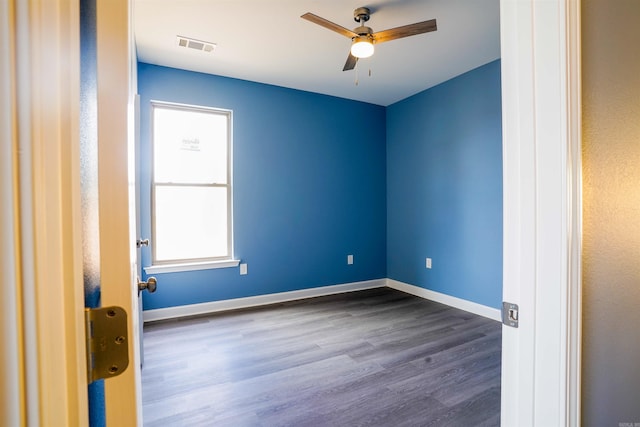 spare room with ceiling fan, dark hardwood / wood-style floors, and plenty of natural light