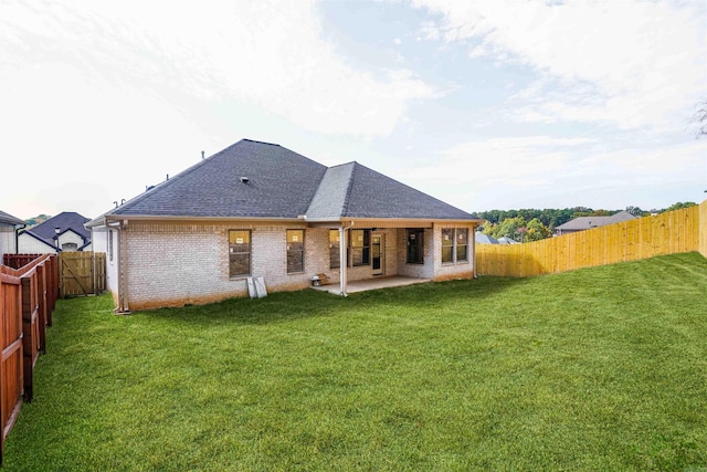 back of property featuring a patio area and a lawn