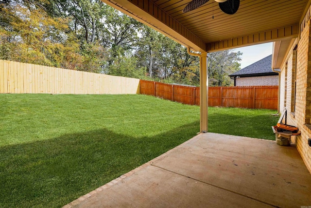 view of yard with ceiling fan and a patio area