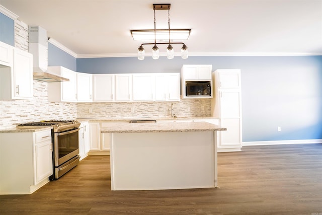 kitchen with wall chimney range hood, dark hardwood / wood-style floors, hanging light fixtures, white cabinets, and gas range