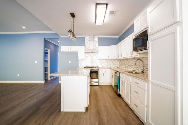 kitchen with stainless steel appliances, sink, white cabinets, wall chimney exhaust hood, and a center island