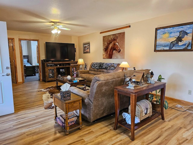 living room with ceiling fan and light hardwood / wood-style floors