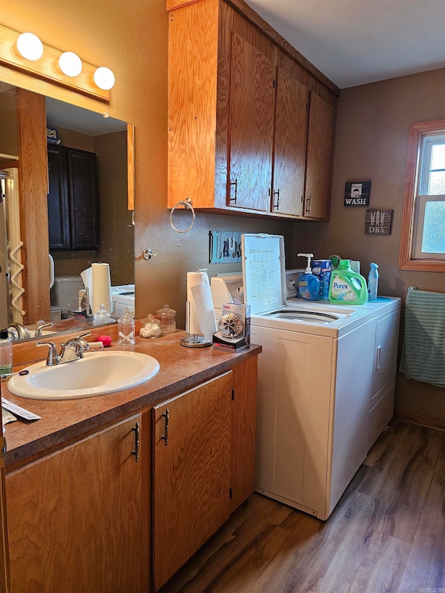 laundry area featuring dark hardwood / wood-style flooring, sink, and separate washer and dryer