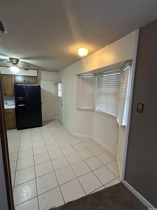 3202 Kendyl, Pine Bluff, AR 71603 - unfurnished dining area with ceiling fan, light tile patterned floors, a textured ceiling, and baseboards