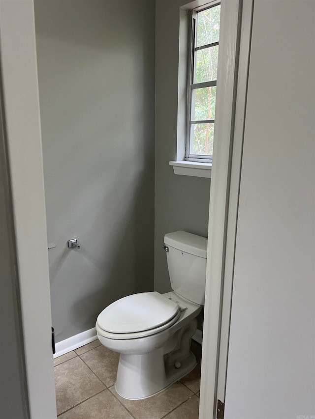 bathroom with tile patterned flooring and toilet