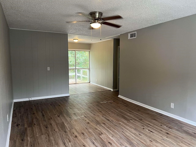 empty room featuring hardwood / wood-style floors, a textured ceiling, and ceiling fan