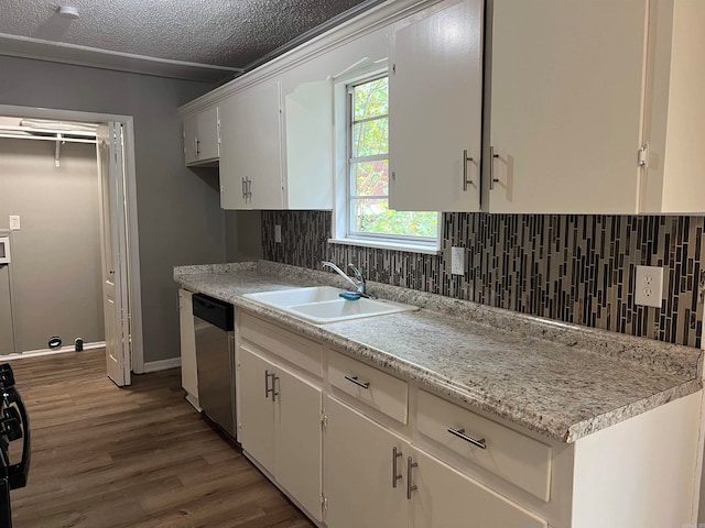 kitchen featuring sink, white cabinetry, a textured ceiling, and stainless steel dishwasher