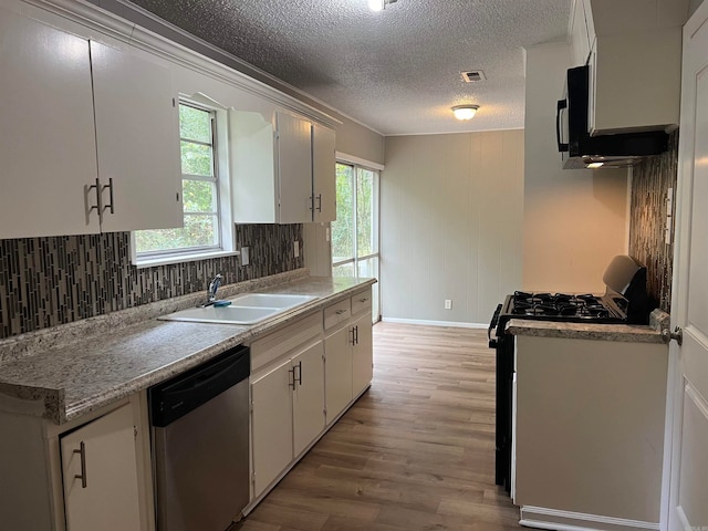 kitchen featuring light hardwood / wood-style floors, dishwasher, sink, a textured ceiling, and white cabinetry