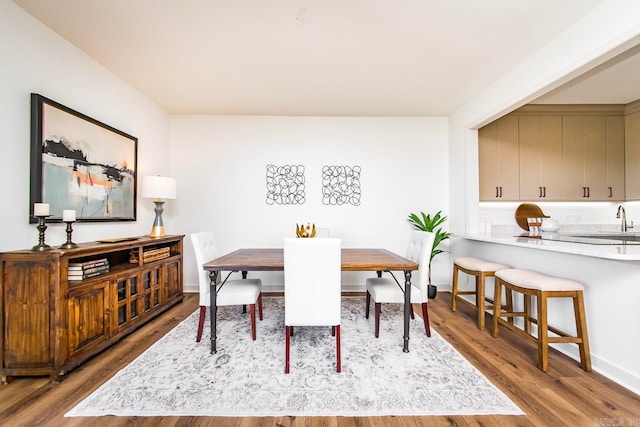 dining space with light hardwood / wood-style floors and sink