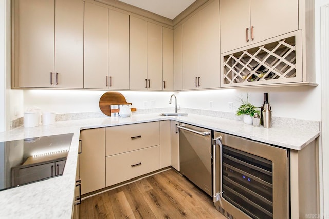 kitchen featuring wine cooler, black electric cooktop, a sink, dishwasher, and light wood finished floors