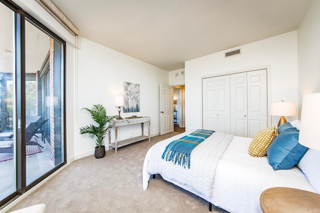 bedroom with baseboards, visible vents, carpet, access to outside, and a closet