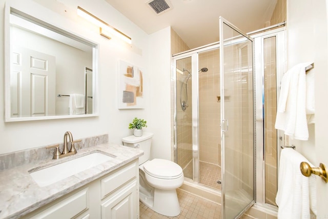 bathroom with toilet, vanity, an enclosed shower, and tile patterned flooring